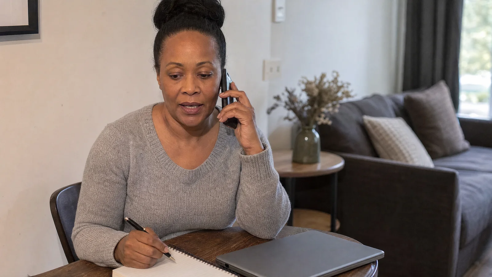 A host making notes during a phone call